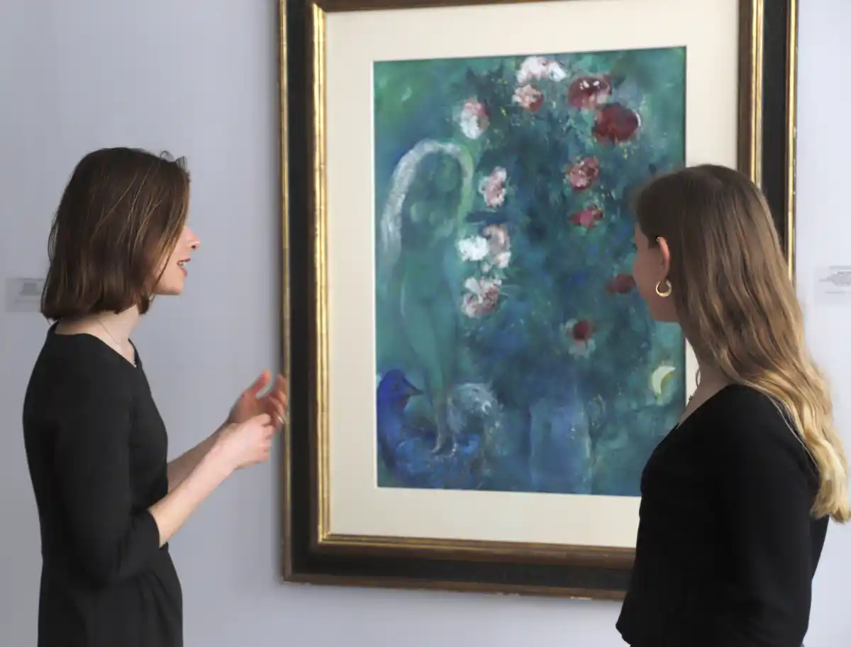 art advisors looking at a pinting