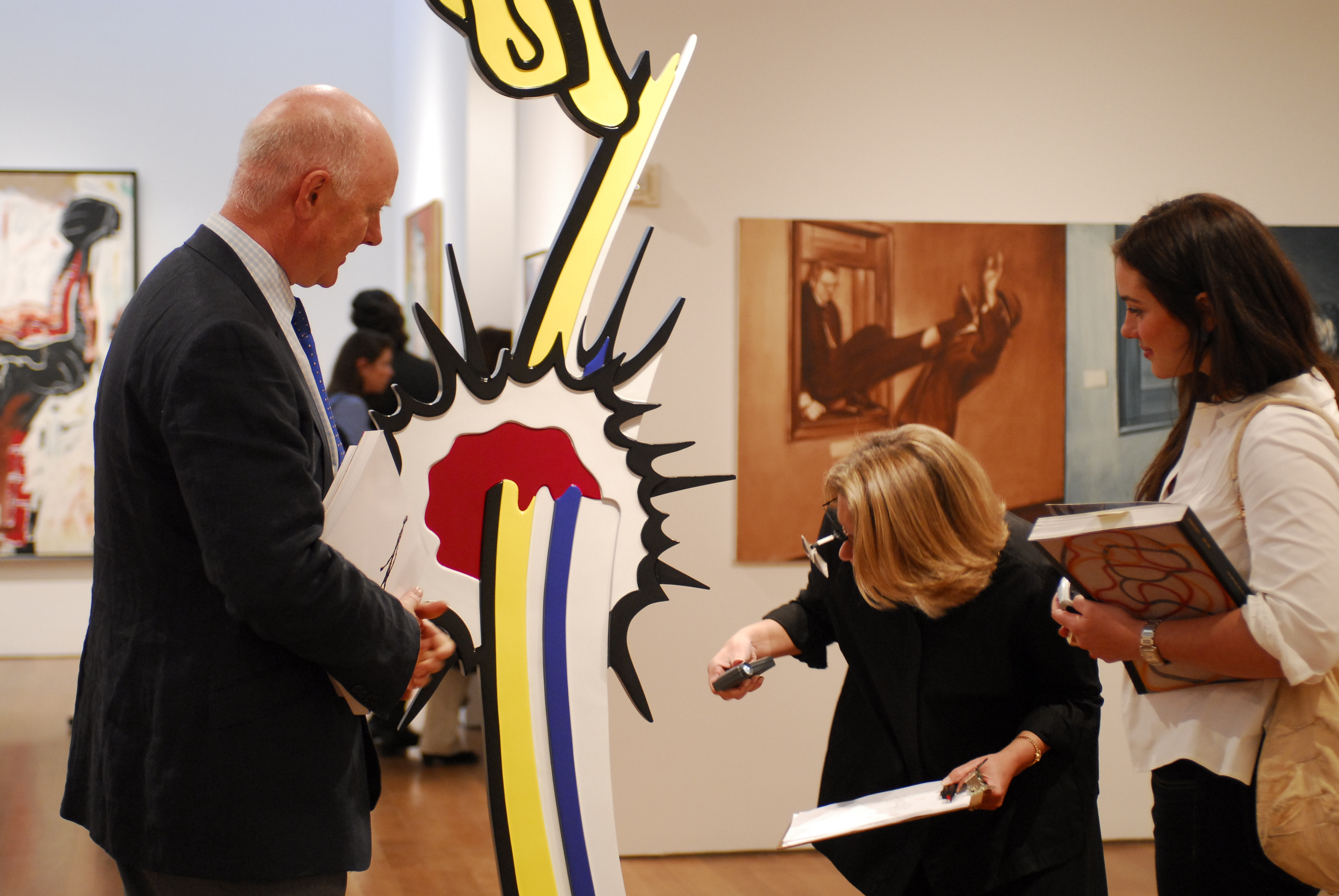Ray Waterhouse examining a Roy Lichtenstein sculpture for a client