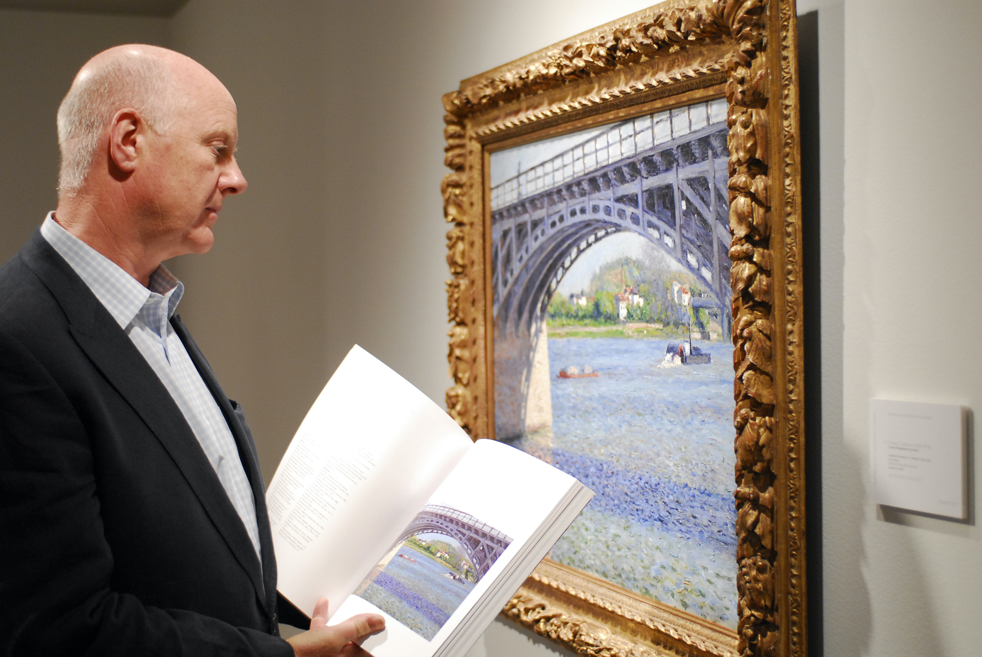 Ray Waterhouse viewing a painting by Gustave Caillebotte at Christies, New York Ray Waterhouse viewing a waterscape painting by Gustave Caillebotte at Christie's auction house while holding an open catalog