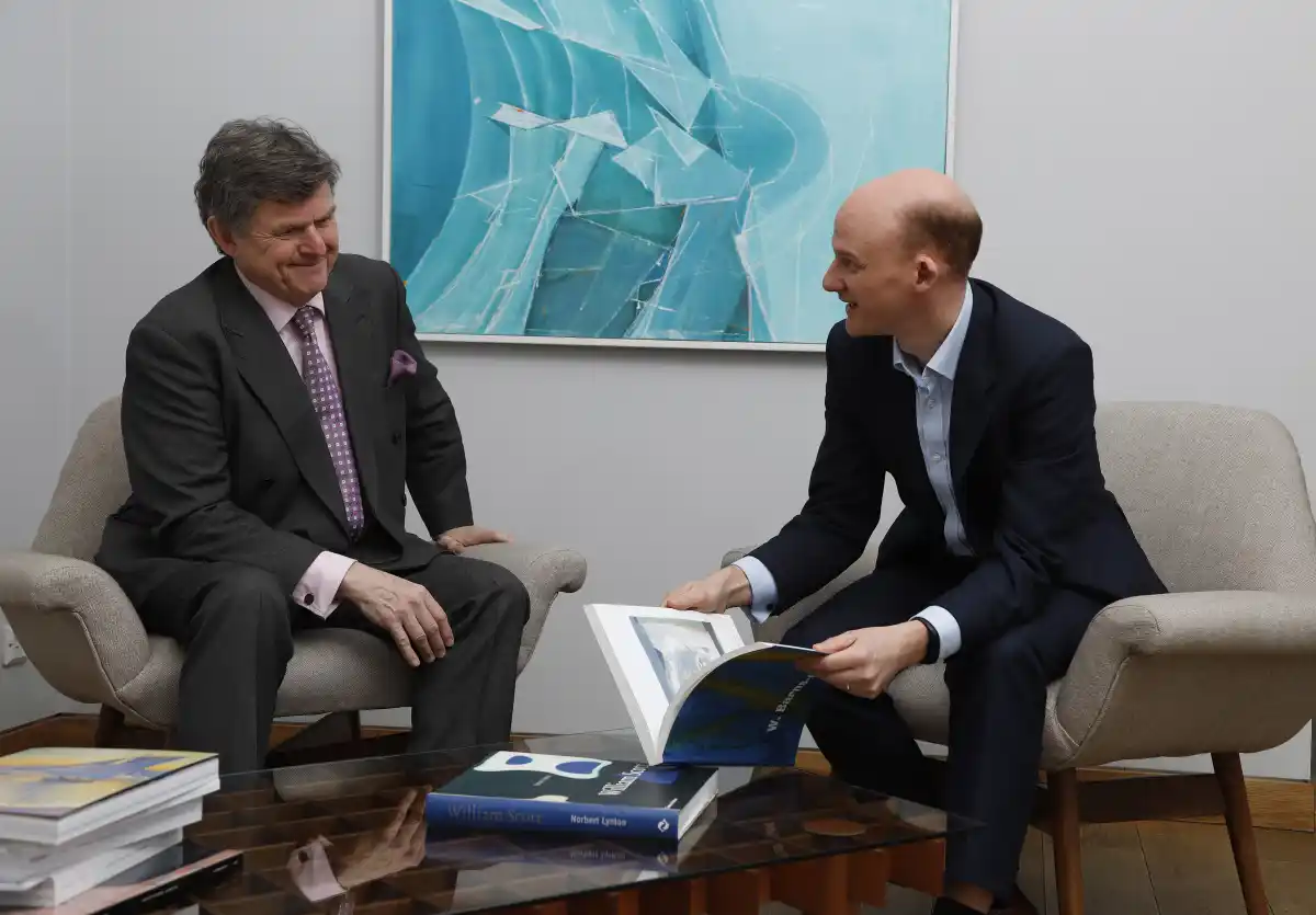 two advisors reviewing a book