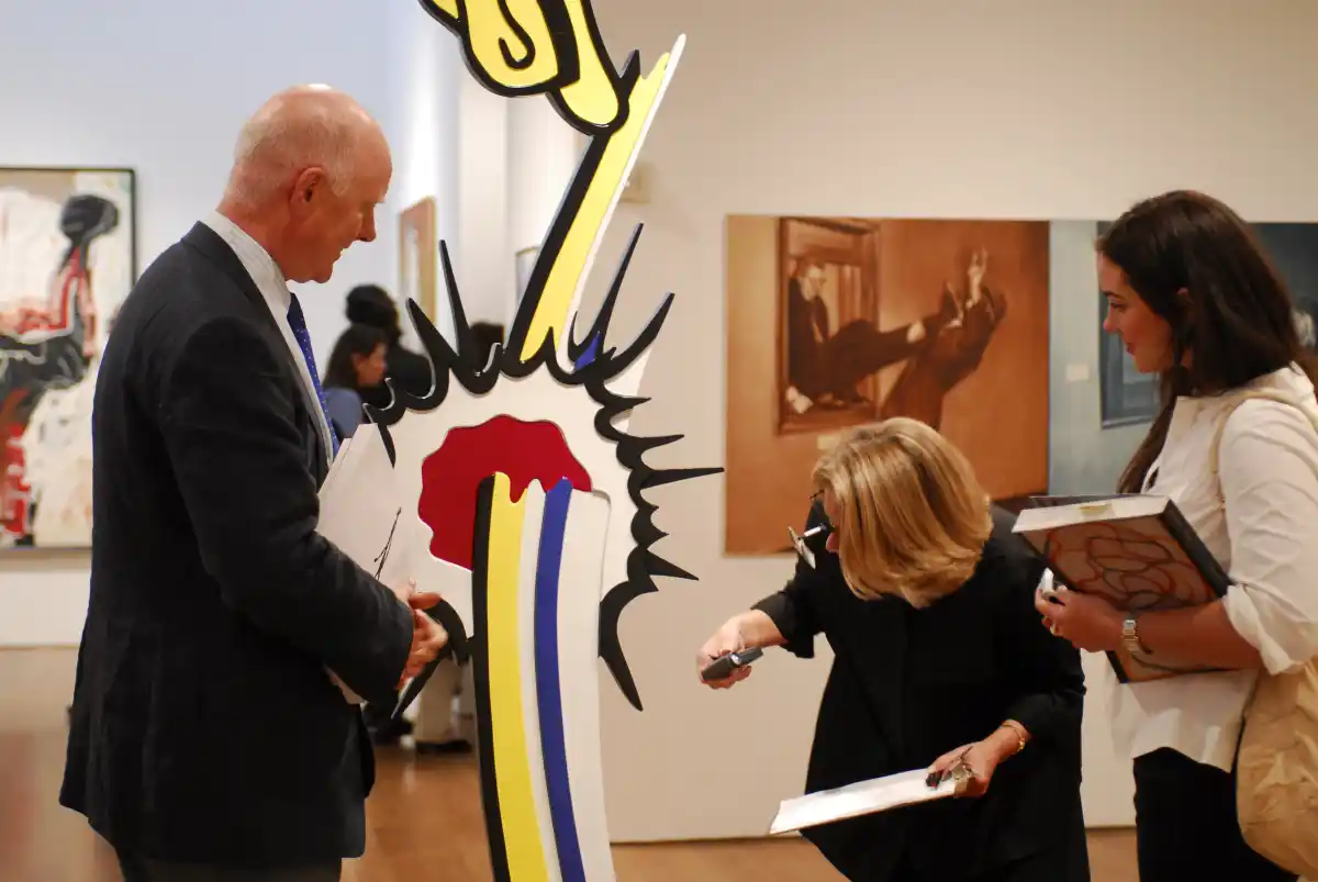 Ray Waterhouse examining a Roy Lichtenstein sculpture for a client