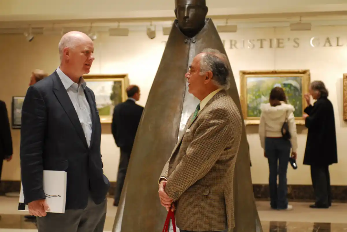 two art advisors discussing an art piece