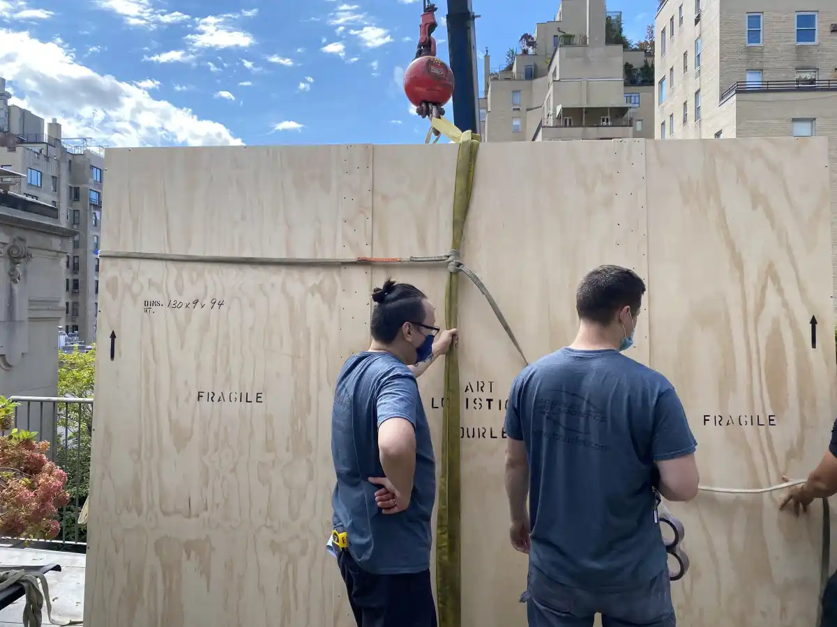 Workers preparing art for shipment